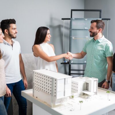 business-partners-shaking-hands-with-engineer-by-architectural-model-meeting-1