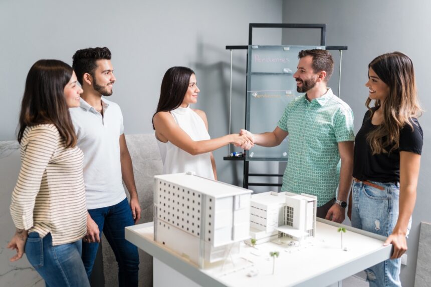 business-partners-shaking-hands-with-engineer-by-architectural-model-meeting-1