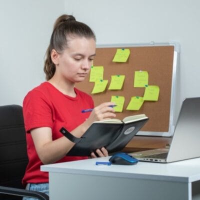female-employee-working-laptop-taking-notes-1-1-1-1-1-1