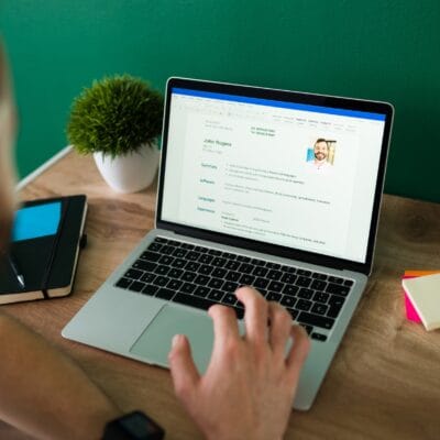 rear-view-adult-man-searching-new-job-working-writing-his-resume-laptop-1-1