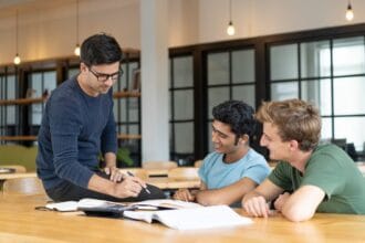 serious-teacher-checking-assignment-two-students_1262-15174