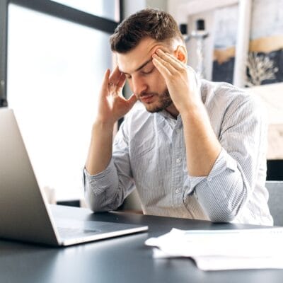 Tired-man-sitting-at-desk-may-have-sleep-apnea-in-Vero-Beach