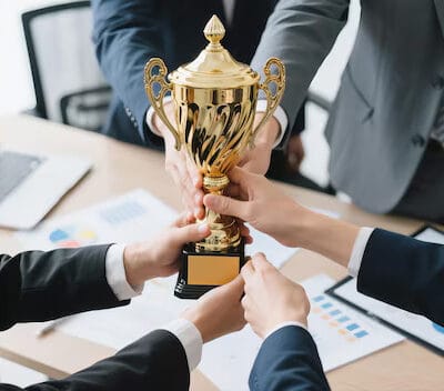 diverse-business-team-celebrating-corporate-success-with-golden-trophy-modern-office-young-professionals-cheerfully-holding-award-team-victory-moment_1240080-558