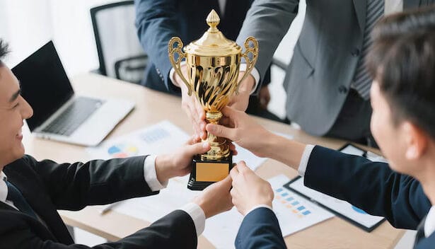 diverse-business-team-celebrating-corporate-success-with-golden-trophy-modern-office-young-professionals-cheerfully-holding-award-team-victory-moment_1240080-558