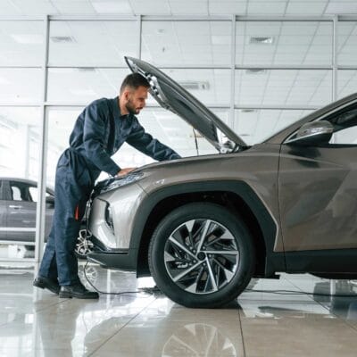 fixing-vehicle-side-view-car-repairman-is-garage-with-automobile-1