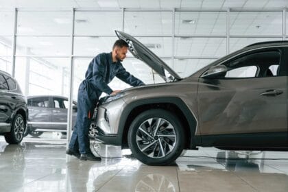 fixing-vehicle-side-view-car-repairman-is-garage-with-automobile-1