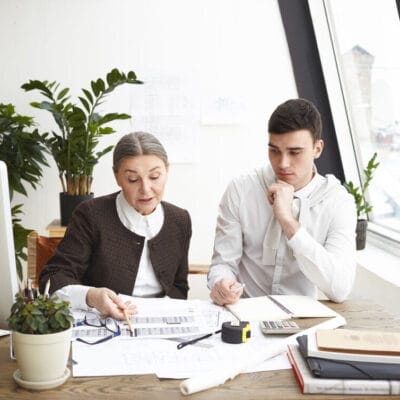people-job-teamwork-cooperation-concept-two-professional-engineers-colleagues-sitting-desk-with-blueprints-computer-engineering-tools-discussing-plans-ideas-having-serious-looks_optimized_2000_1_optimized_250