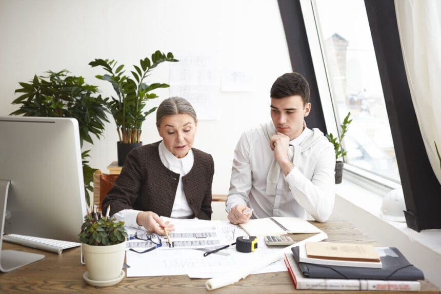 people-job-teamwork-cooperation-concept-two-professional-engineers-colleagues-sitting-desk-with-blueprints-computer-engineering-tools-discussing-plans-ideas-having-serious-looks_optimized_2000_1_optimized_250