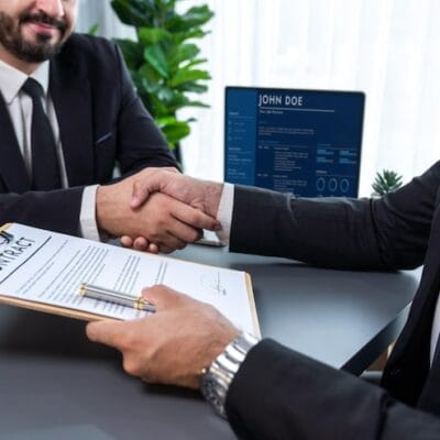 two-men-shaking-hands-with-contract-front-computer-screen-that-says-join-500_31965-149912