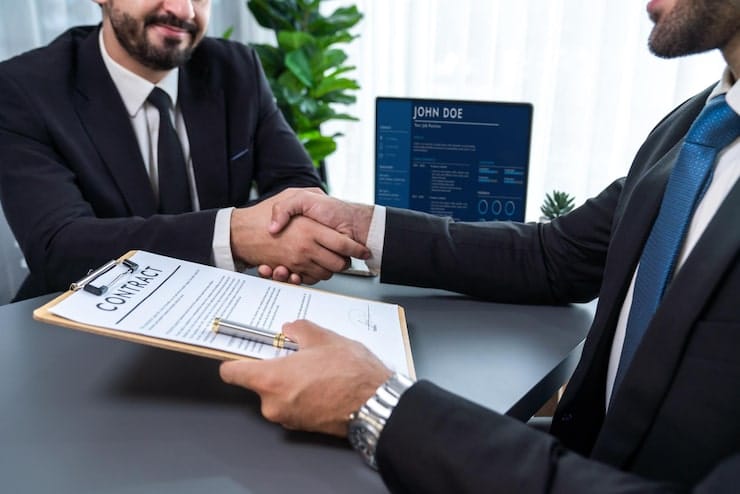 two-men-shaking-hands-with-contract-front-computer-screen-that-says-join-500_31965-149912