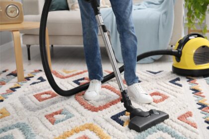 man-with-vacuum-cleaning-carpet-living-room-closeup
