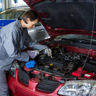 female-mechanic-checking-oil-level-car-engine-1