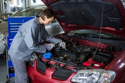 female-mechanic-checking-oil-level-car-engine-1